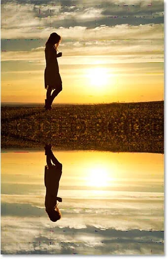 A água agora reflete a imagem acima dela. efeito de reflexo no Photoshop com ondulações