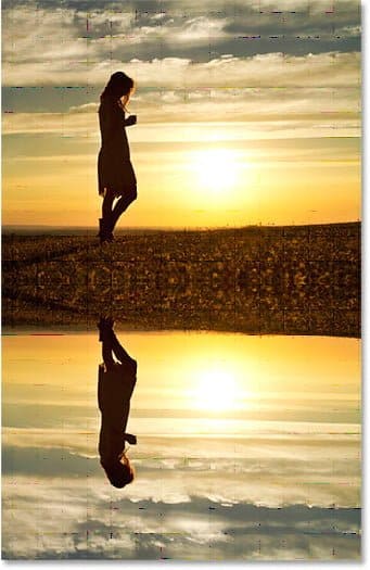 A água agora reflete a imagem acima dela. efeito de reflexo no Photoshop com ondulações